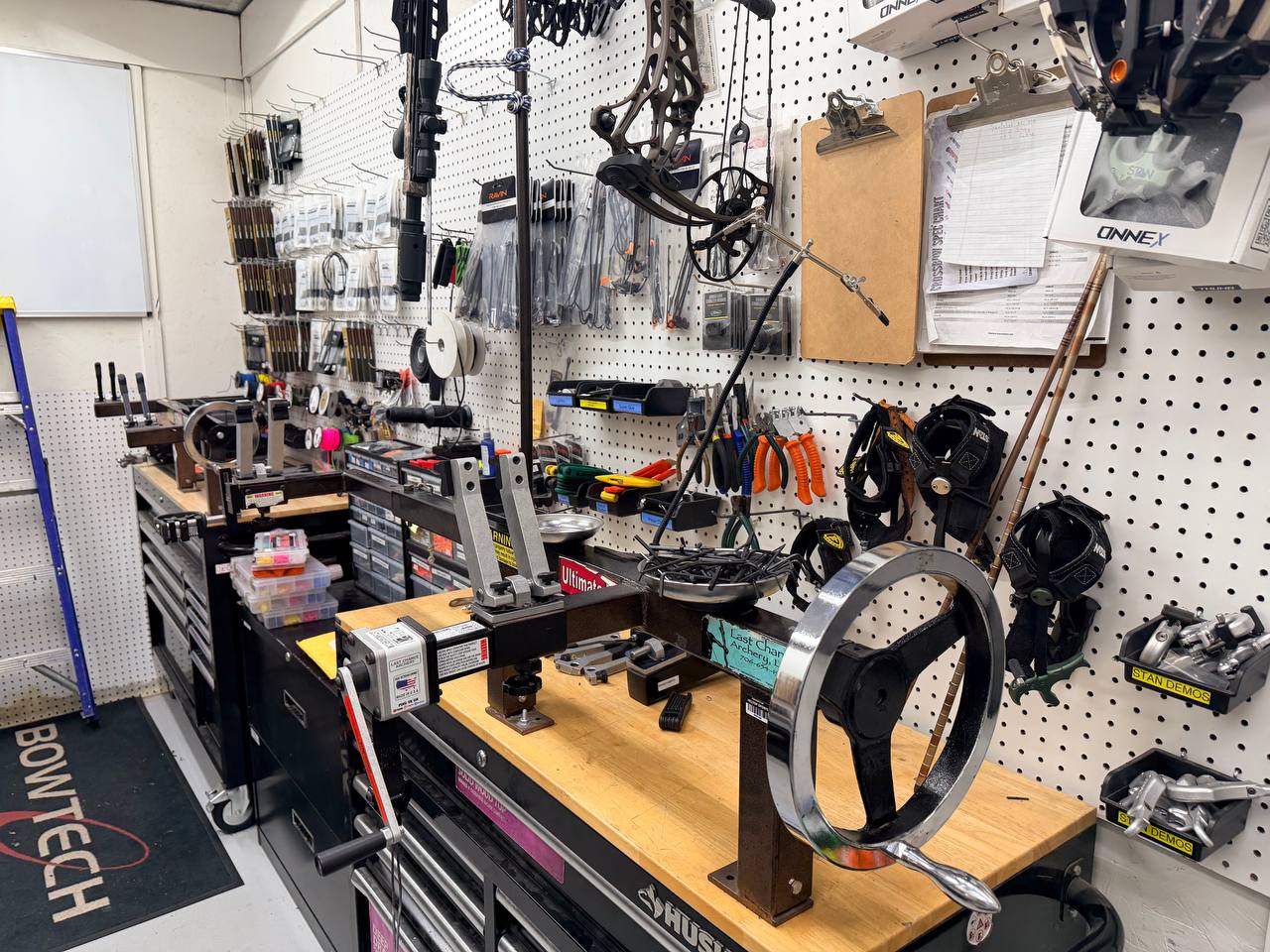 A Hilltop Sports tech dialing in gear at the service bench